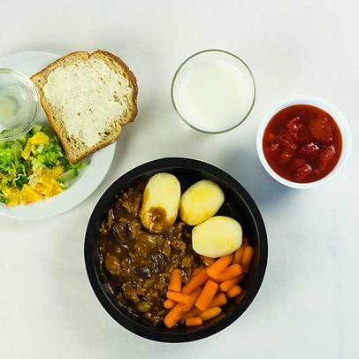 A home meal supplemented with bread, spread and a drink.