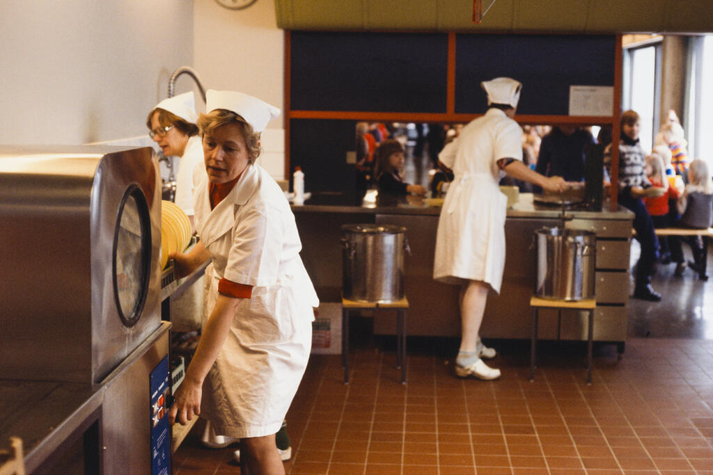 Schools food service workers preparing food in 1977.